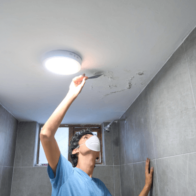 man fixes leak for mold prevention