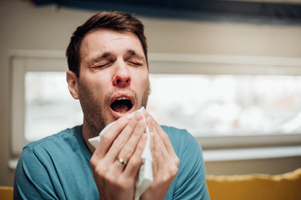 man sneezes from mold and allergies