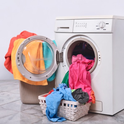 washing machine smells with colorful clothes hanging out